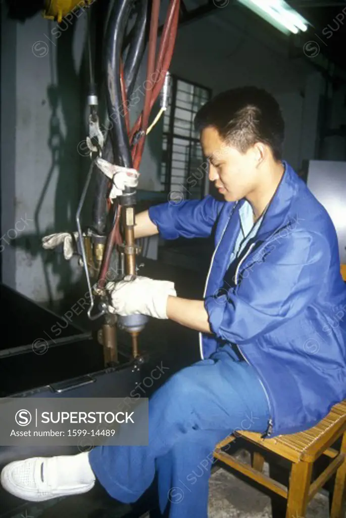 Factory workers at Shanghai Shangling Electric Appliances Company, Ltd., in Shanghai, People's Republic of China