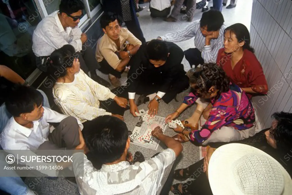 Card players waiting at Kunming Airport in Kunming, Yunnan Province, People's Republic of China