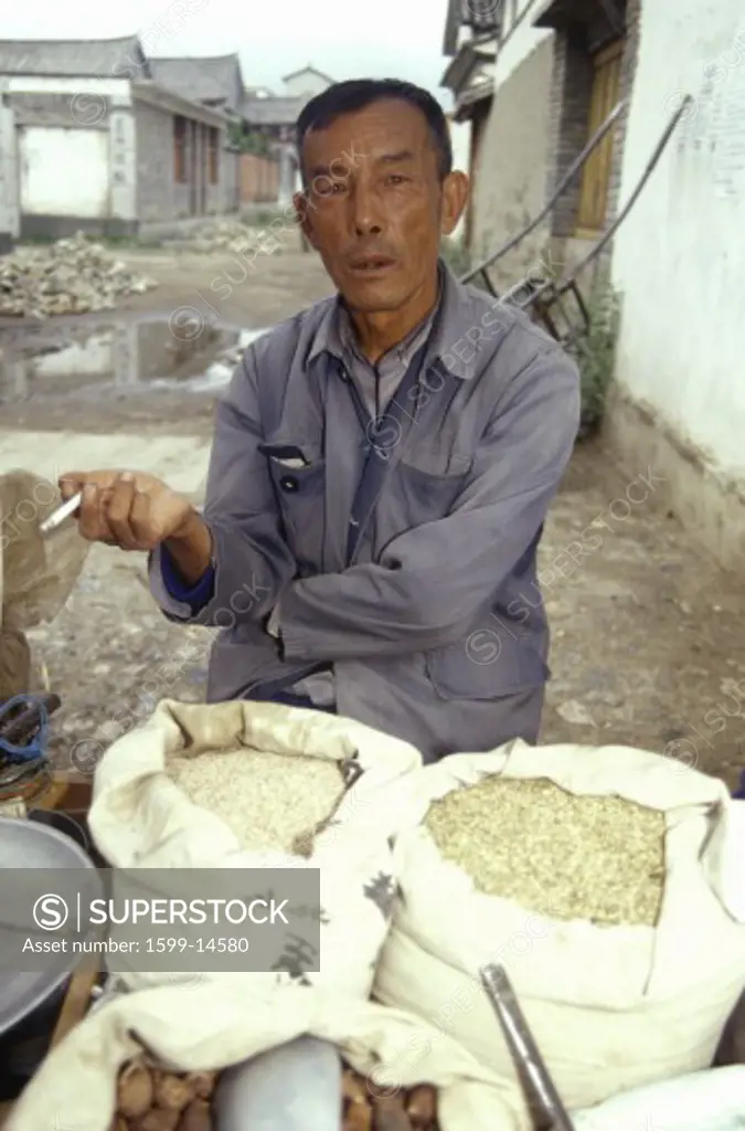Man selling grains in Bei Village in Dali, Yunnan Province, People's Republic of China