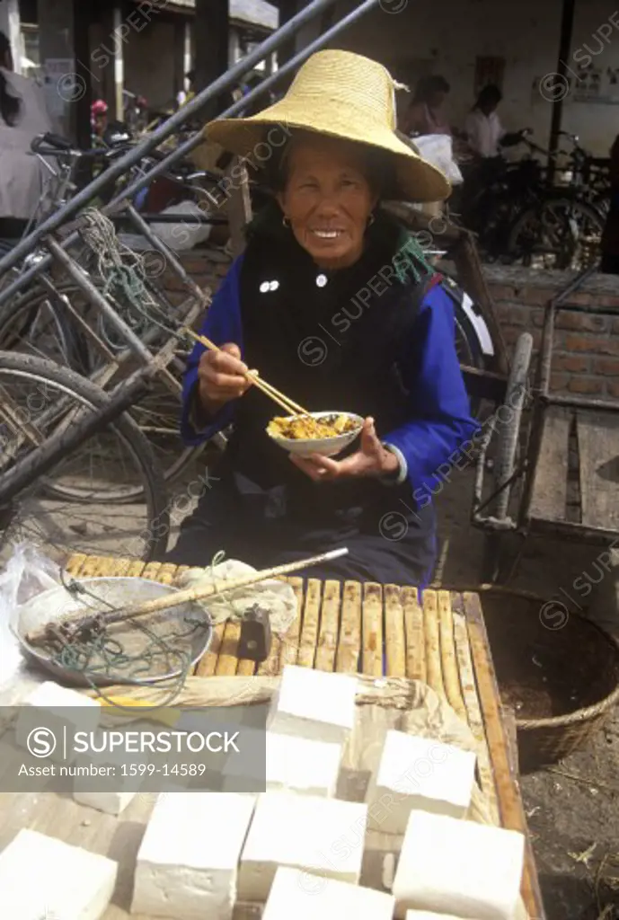 Woman eating lunch at the Bei Marketplace in Dali, Yunnan Province, People's Republic of China