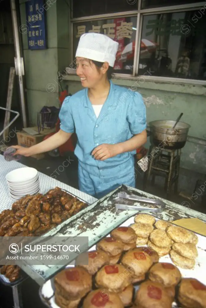 Baker with goods in the Hutongs in Beijing in Hebei Province, People's Republic of China