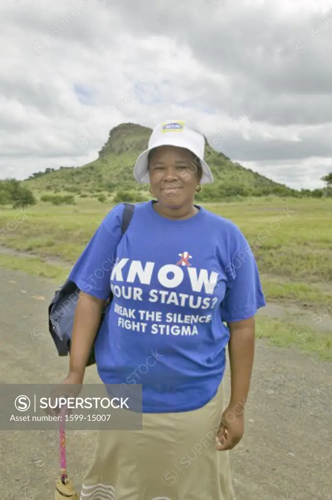 Black Zulu woman with t-shirt about AIDS infection, at the scene of the Anglo Zulu battle site of January 22, 1879. The great Battlefield of Isandlwana and the Oskarber, Zululand ,northern Kwazulu Natal, South Africa