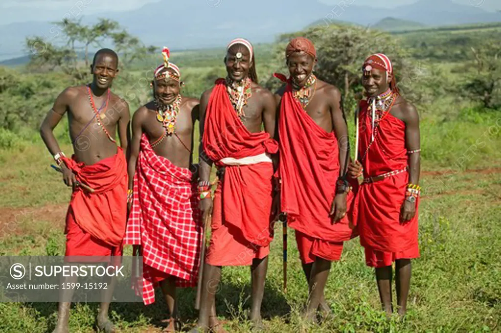 Group portrait of five Masai Warriors in traditional red toga at Lewa Wildlife Conservancy in North Kenya, Africa