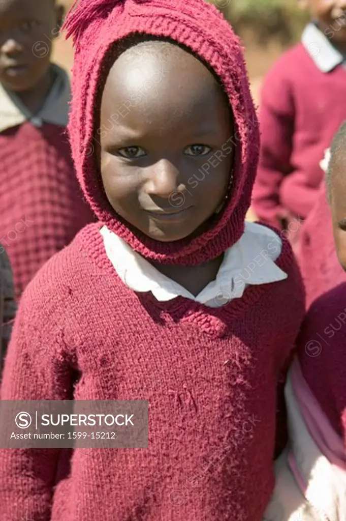 Karimba School with closeup of young girl in maroon sweater in North Kenya, Africa