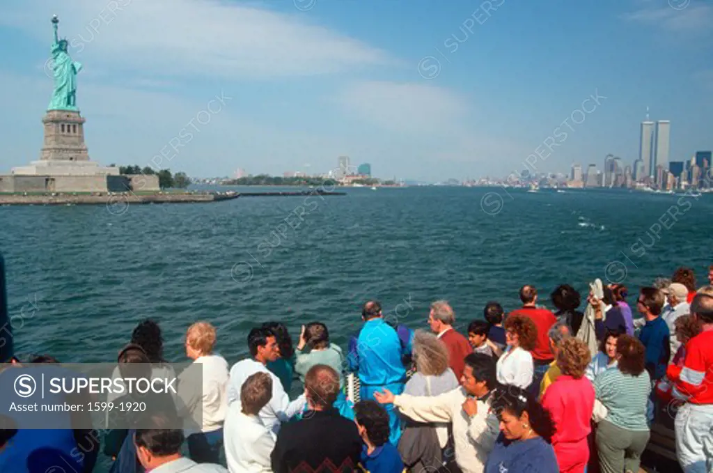 Tourists viewing Statue of Liberty from the Circle Line boat tour of Ellis Island, New York, New York