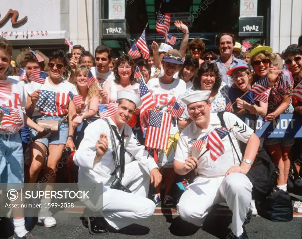 Sailors and crowd waving American flags at Desert Storm Victory parade in New York City, New York