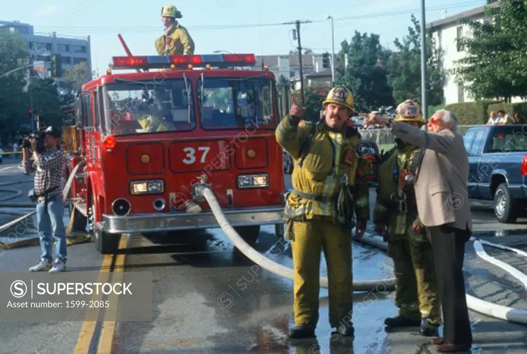 Firefighters with a witness at condominium in Brentwood, California                
