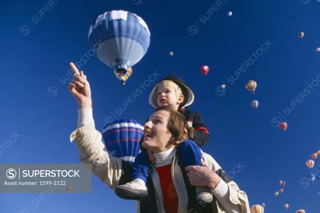 Father with young son on his shoulders, Albuquerque's Hot Air Balloon Festival, New Mexico