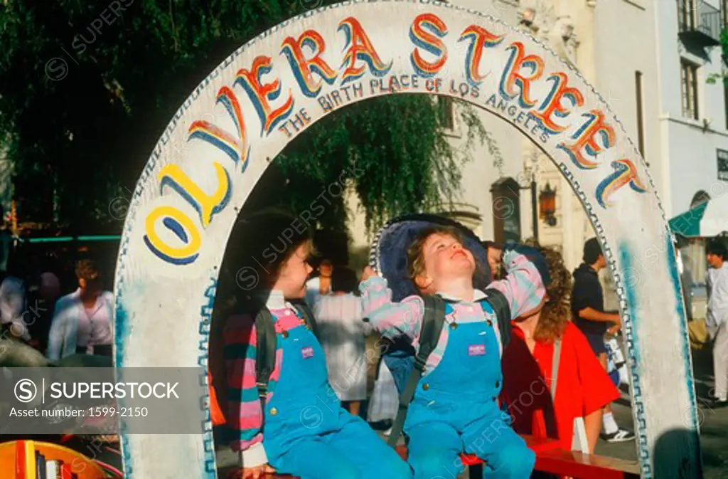 Girls in overalls at Cinco de Mayo celebration, Olvera Street, Los Angeles, California