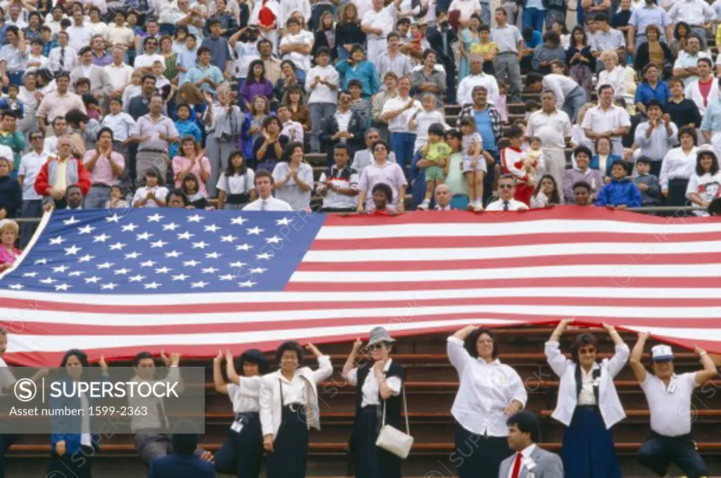 Crowd at sports event with large American flag
