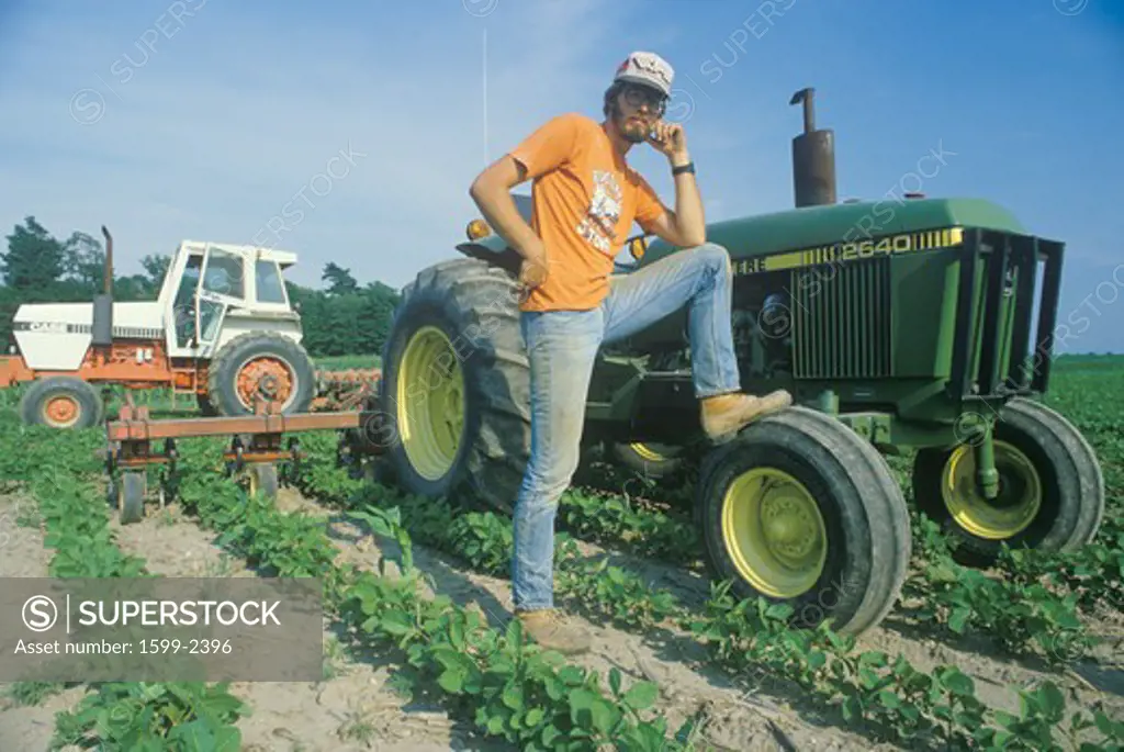 Farmer tending to soybeans by a tractor in Edwardsburgh, MI
