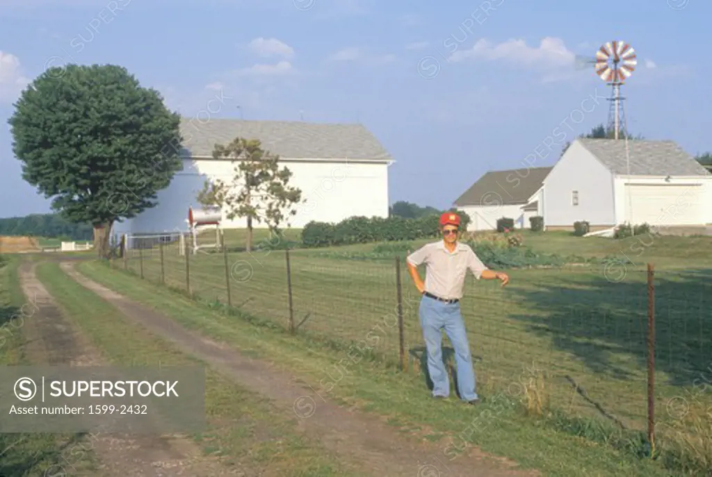 A farmer standing by a fence during a drought in South Bend, IN