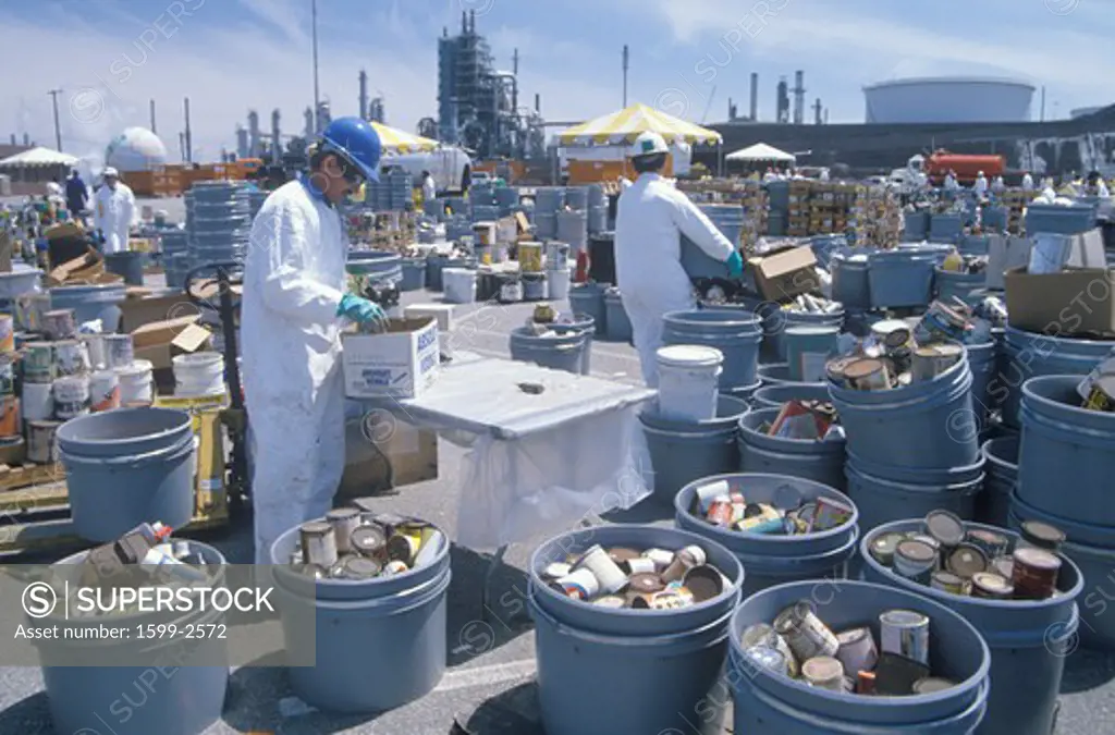 Workers handling toxic household wastes at waste cleanup site on Earth Day at the Unocal plant in Wilmington, Los Angeles, CA