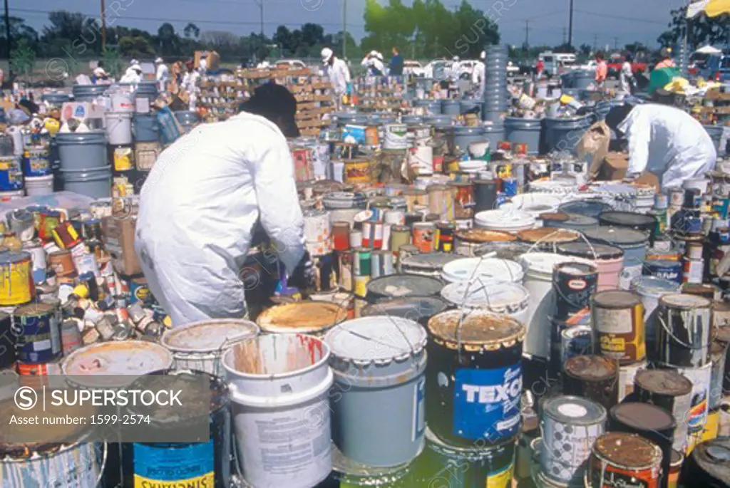 Workers handling toxic household wastes at waste cleanup site on Earth Day at the Unocal plant in Wilmington, Los Angeles, CA