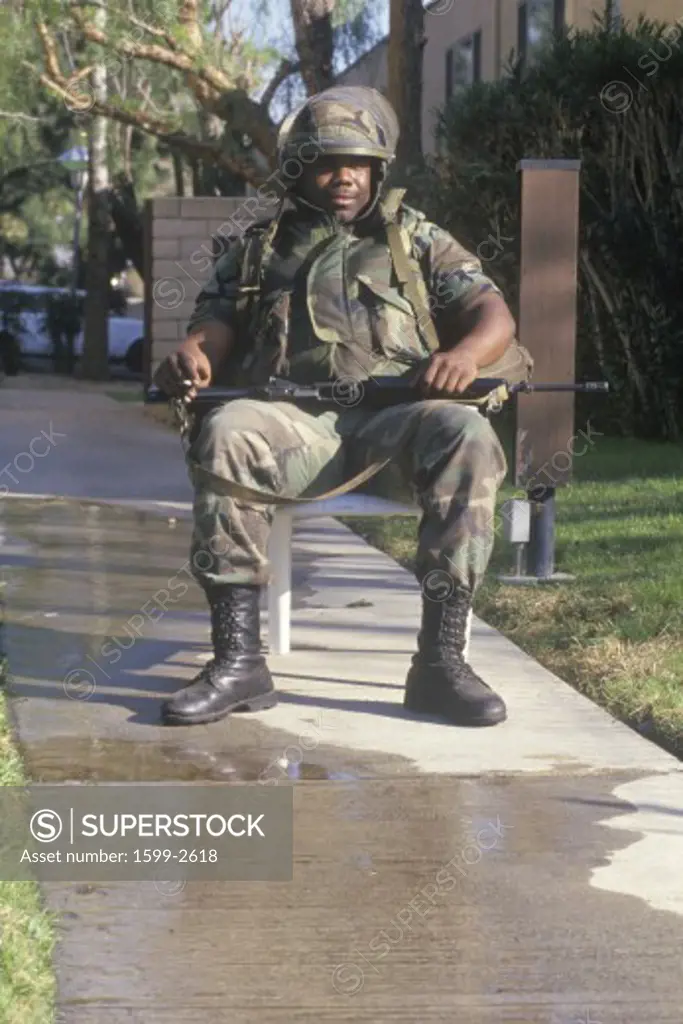 A National Guard member in riot gear outside a Los Angeles building after the earthquake of January 17, 1994 