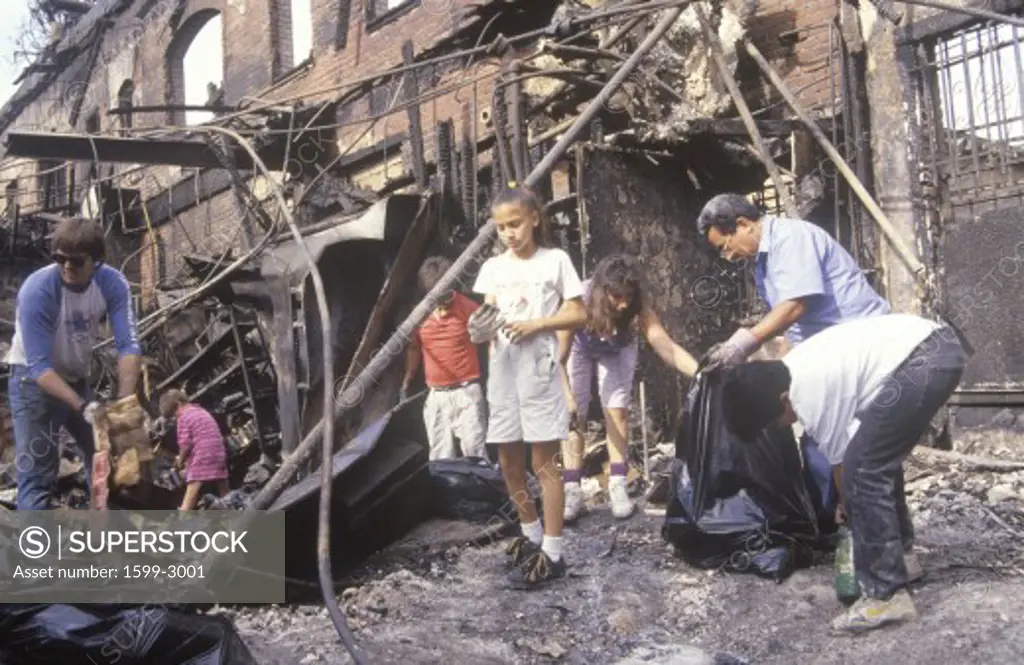 Family rummaging through home burned during riots, South Central Los Angeles, California