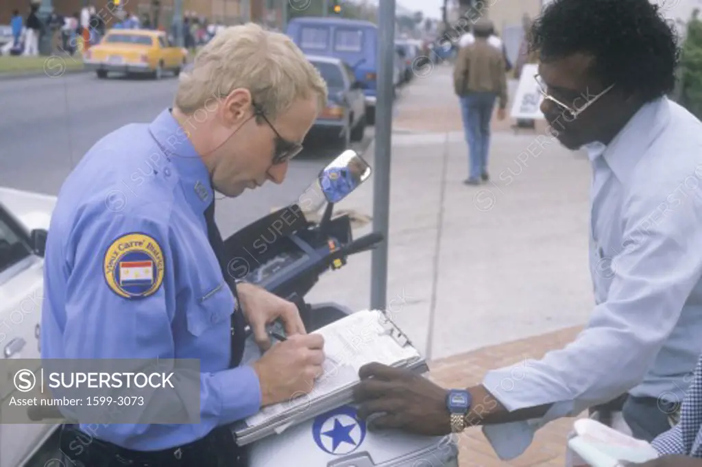 Police officer writing ticket, New Orleans, Louisiana