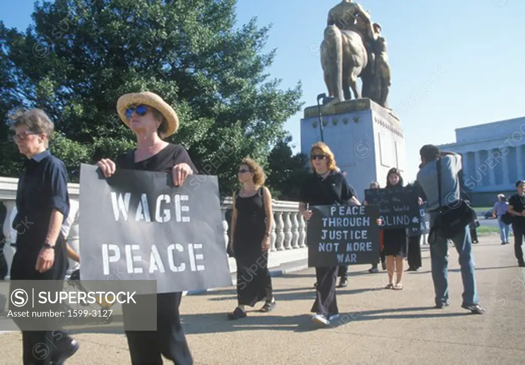 Anti-war protester in black marching at rally, Washington D.C.