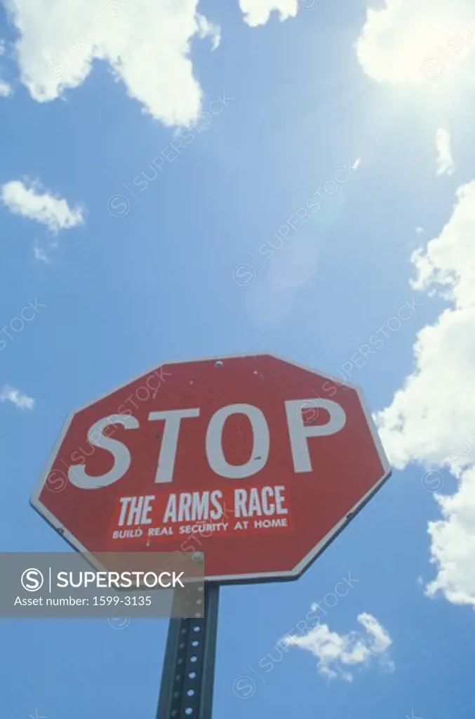 Stop sign with The arms race” added