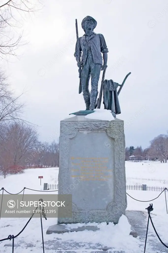 Minuteman statue at Old North Bridge in snow, Concord, Ma., New England, USA, the historical site of the Battle of Concord, the first day of battle in the American Revolutionary War