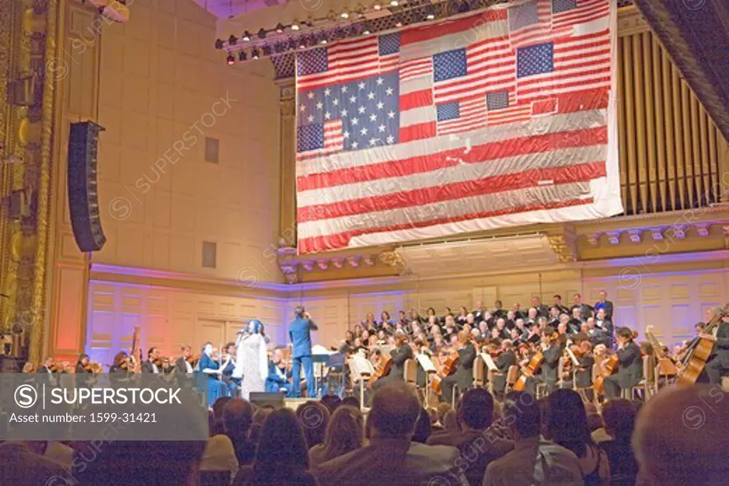 9/11 flag hangs over Keith Lockhart as he conducts the Boston Pops at Symphony Concert Hall, Boston, Ma., USA