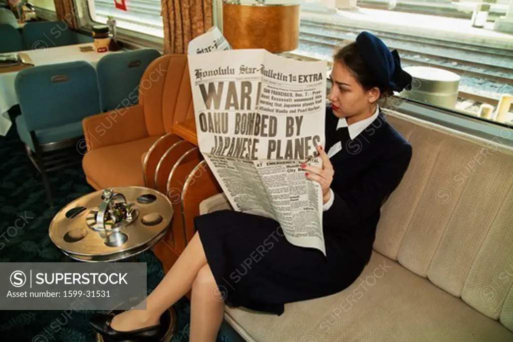 1940's reenactor reads December 12, 1941 newspaper on Pearl Harbor Day Troop train reenactment from Los Angeles Union Station to San Diego
