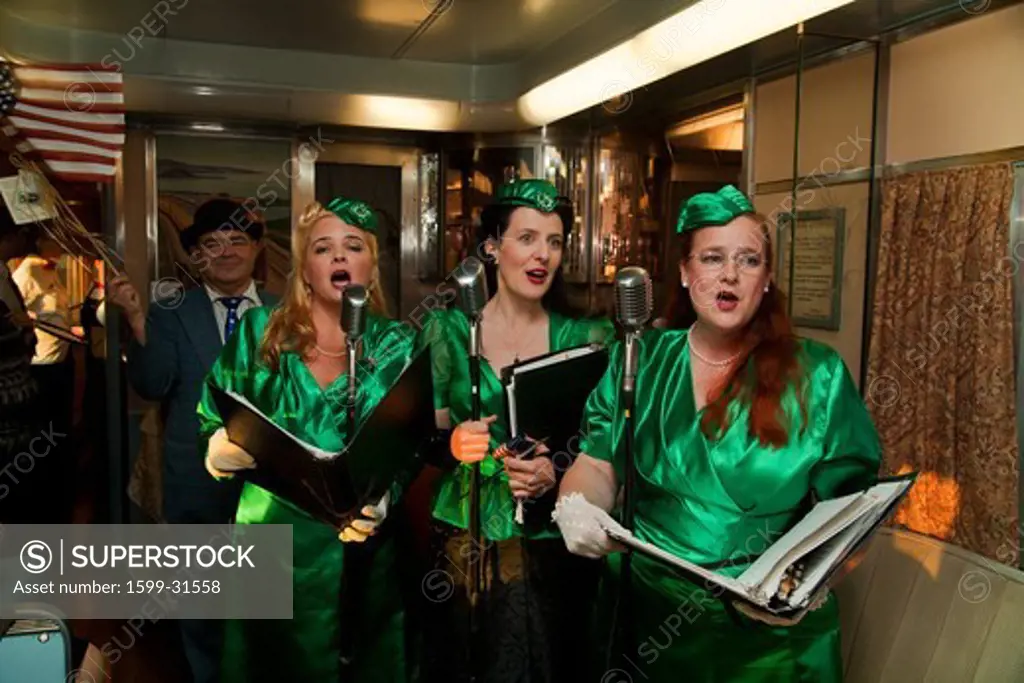 1940's female reenactors sing on Pearl Harbor Day Troop train reenactment from Los Angeles Union Station to San Diego