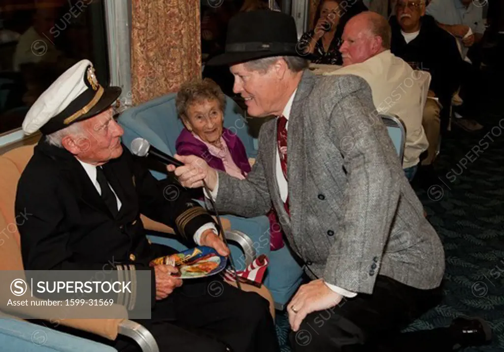 1940's man interviews veteran of Pearl Harbor Day on Pearl Harbor Day Troop train reenactment from Los Angeles Union Station to San Diego