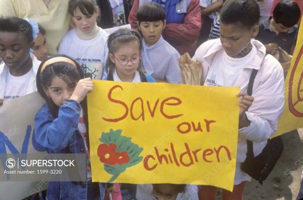 Children holding signs at anti-gang community march, East Los Angeles, California