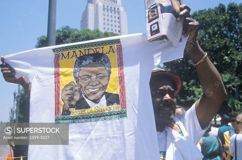Man holding up Nelson Mandela t-shirt, Los Angeles, California
