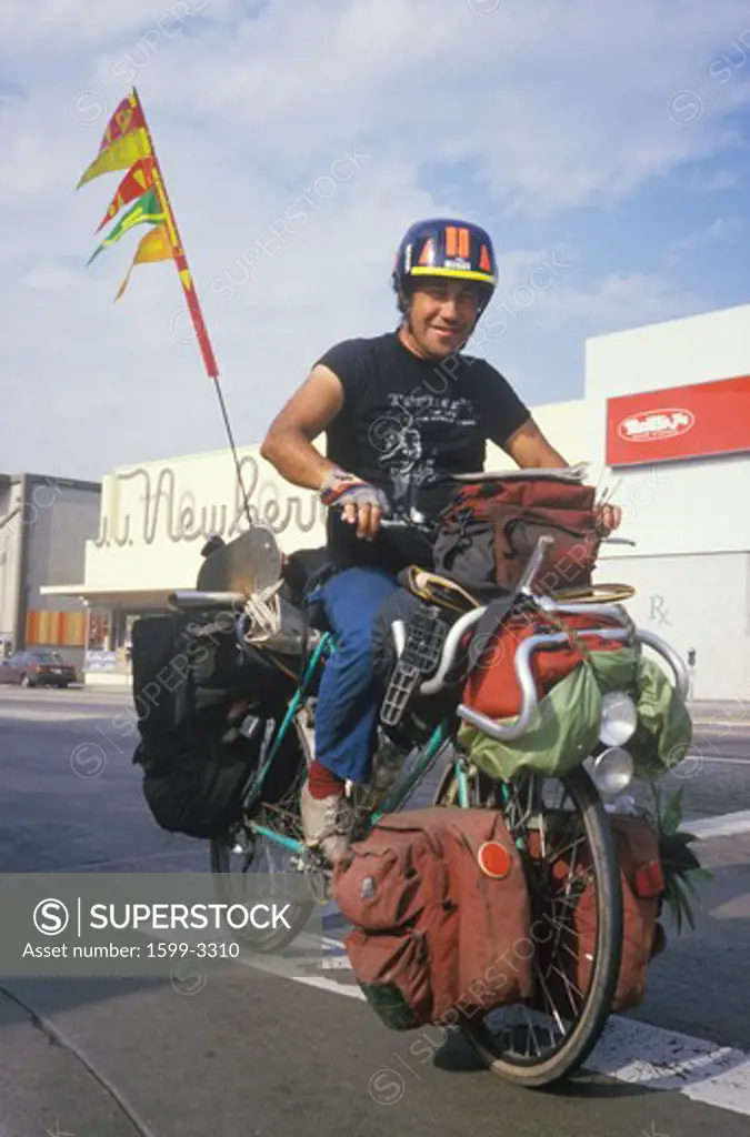 Homeless Latino riding bicycle, Santa Monica, California