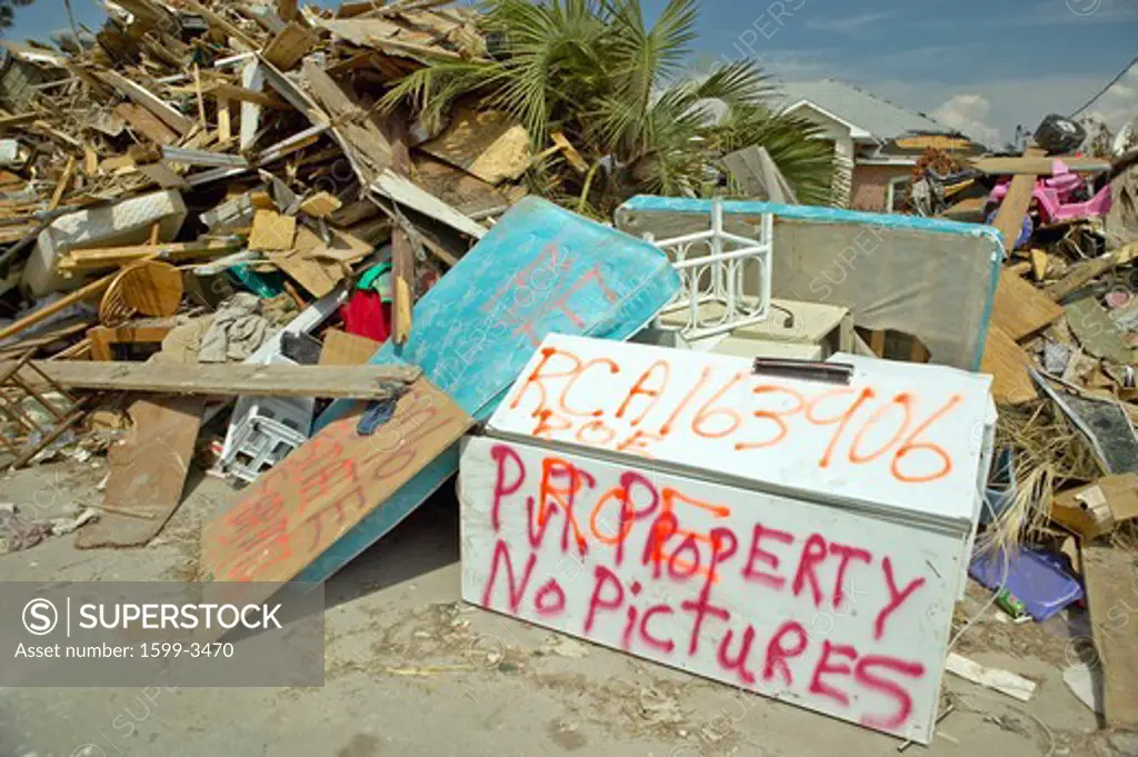 No pictures sign and debris in front of house heavily hit by Hurricane Ivan in Pensacola Florida