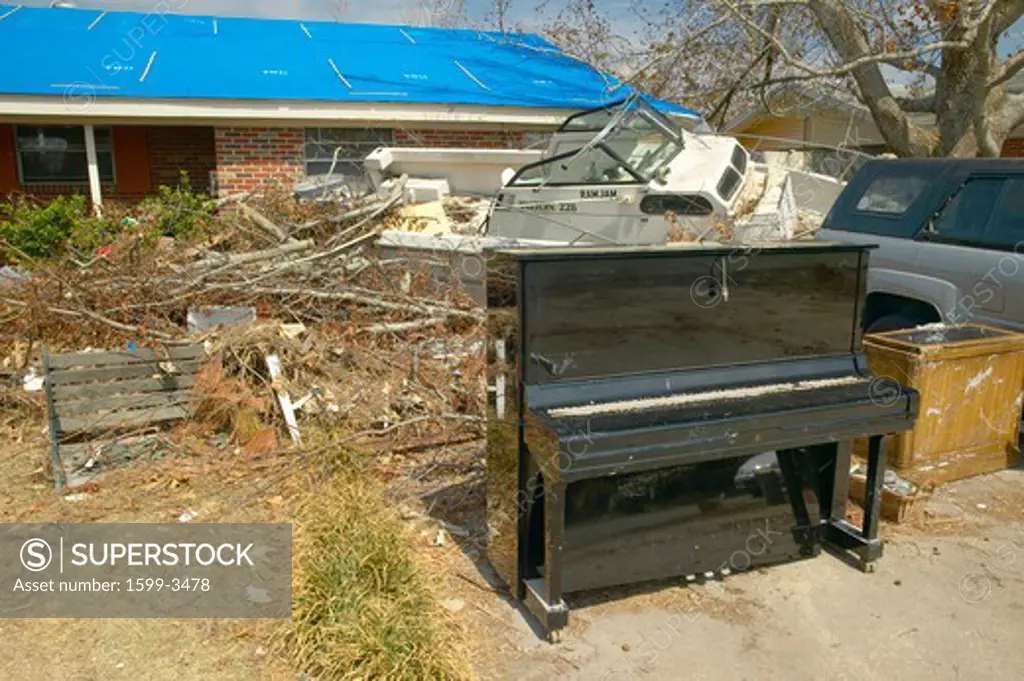 Piano and debris in front of house heavily hit by Hurricane Ivan in Pensacola Florida