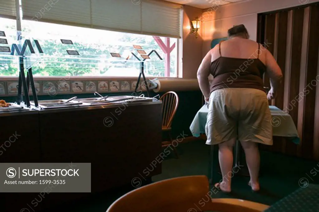 Overweight woman eats at buffet in Eastern Shore, Maryland
