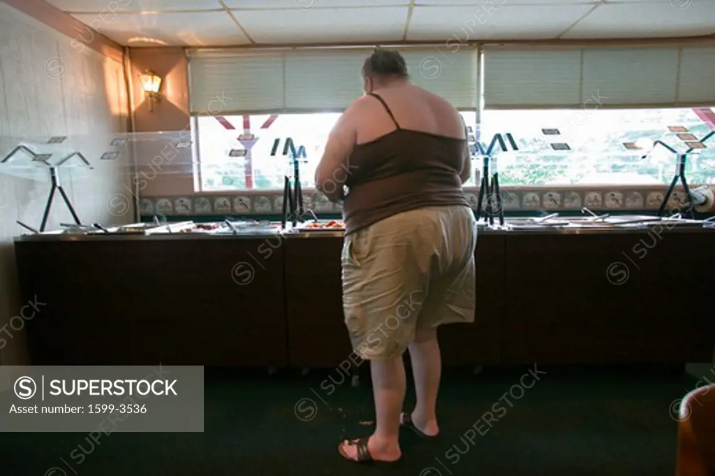 Overweight woman eats at buffet in Eastern Shore, Maryland