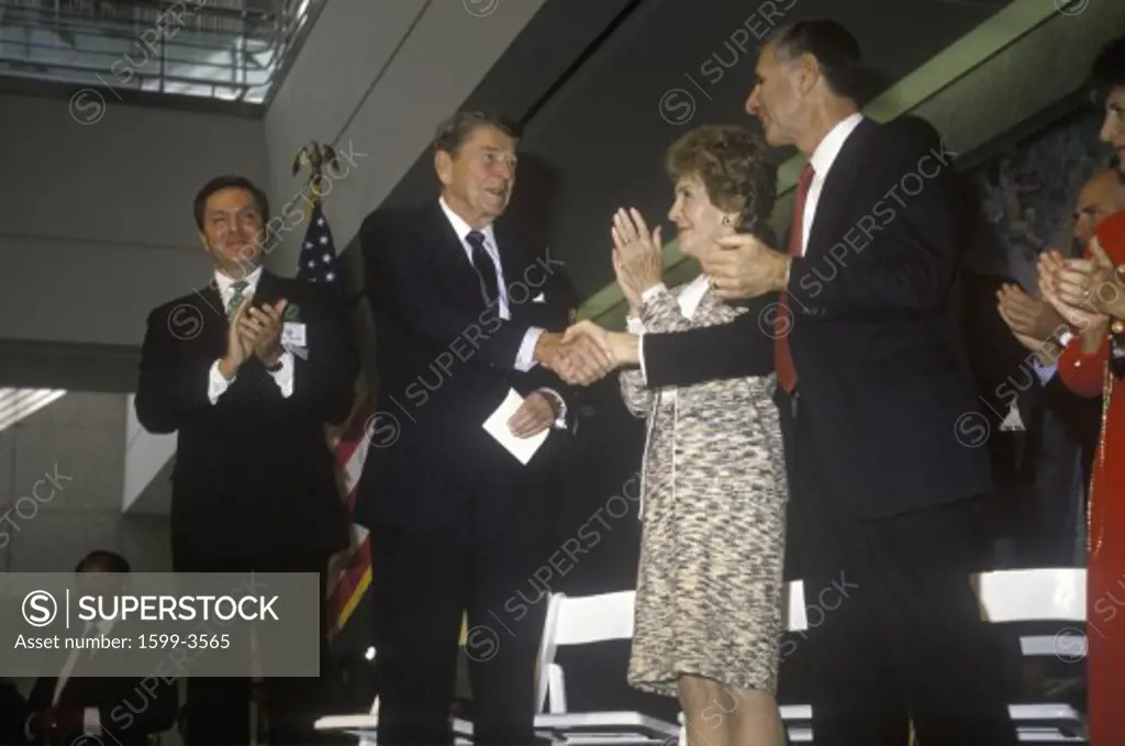 President Ronald Reagan, Mrs. Reagan and California governor George Deukmejian applaud Ronald Reagan