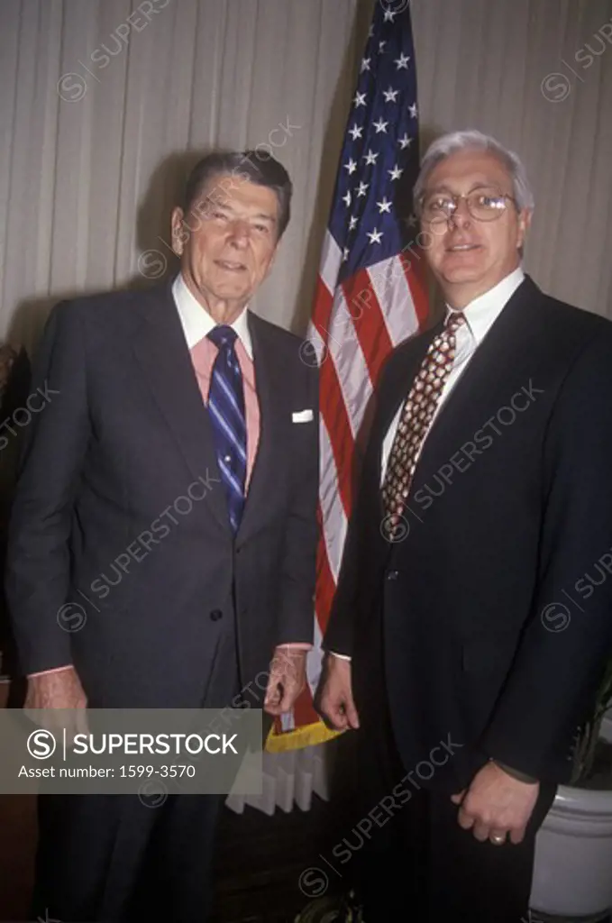 President Ronald Reagan and a politician posing