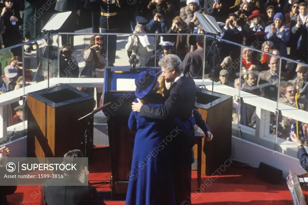 Bill Clinton, 42nd President, embraces wife Hillary Clinton and daughter Chelsea on Inauguration Day 1993, Washington, DC