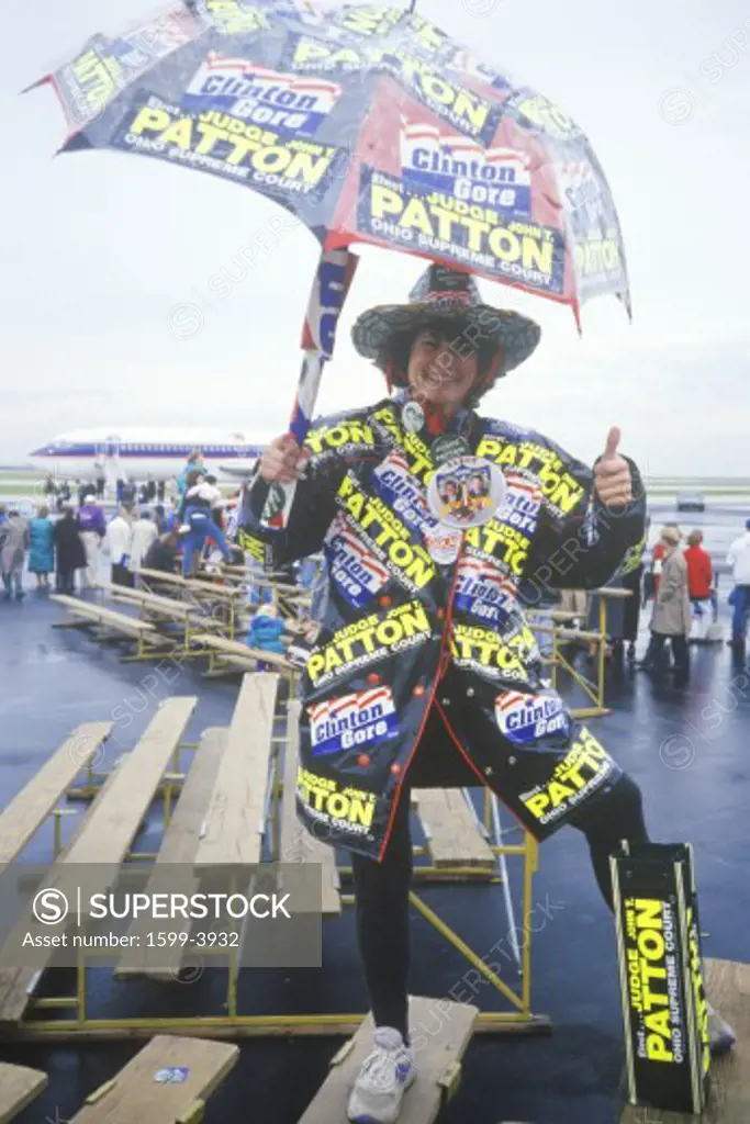 Woman shows off Clinton/Gore stickers on her rainwear, 1992