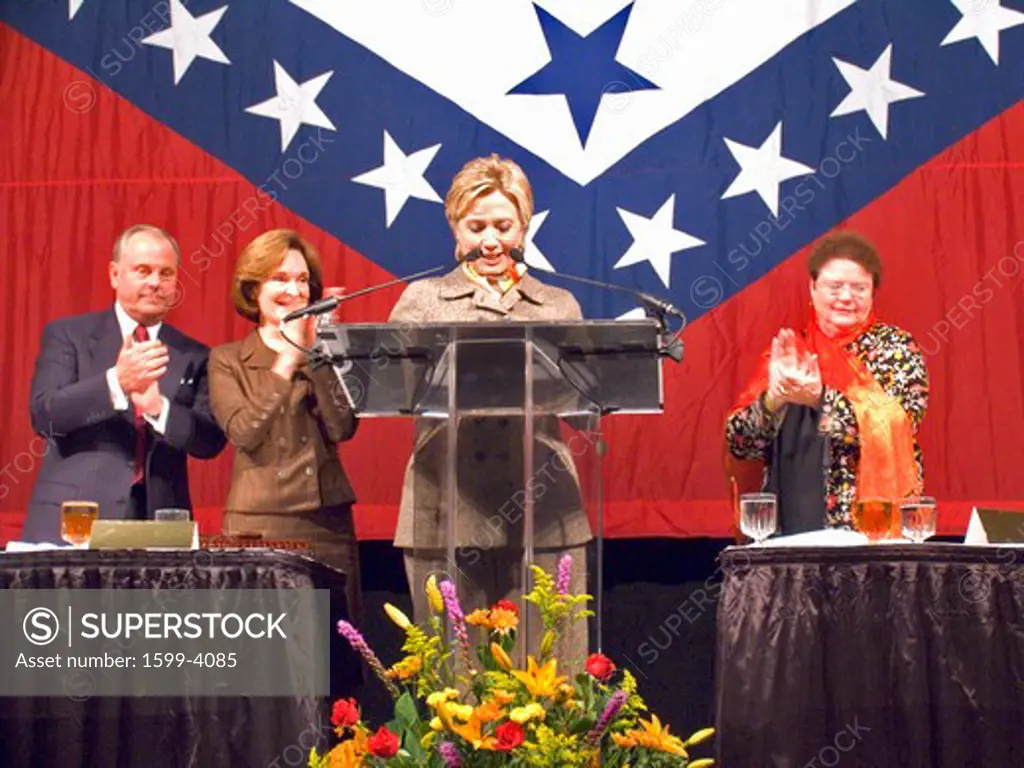 Sen. Hillary Clinton (D-NY), wife of former U. S. Former President Bill Clinton, speaks at a Little Rock, AK luncheon honoring the First Ladies of the state in front of the state flag November 17, 2004 in Little Rock, AK