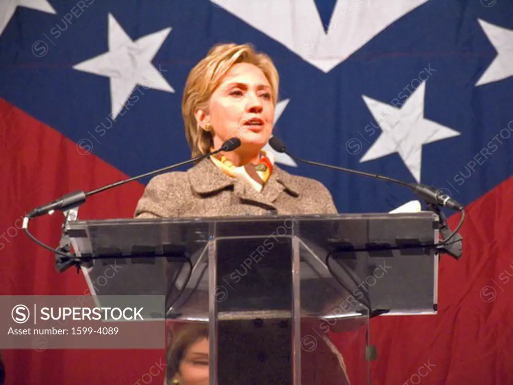 Sen. Hillary Clinton (D-NY), wife of former U. S. Former President Bill Clinton, speaks at a Little Rock, AK luncheon honoring the First Ladies of the state in front of the state flag November 17, 2004 in Little Rock, AK