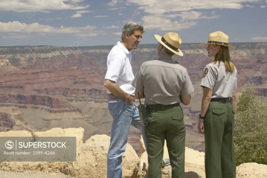 Senator John Kerry speaking with 2 rangers at rim of Bright Angel Lookout, Grand Canyon, AZ