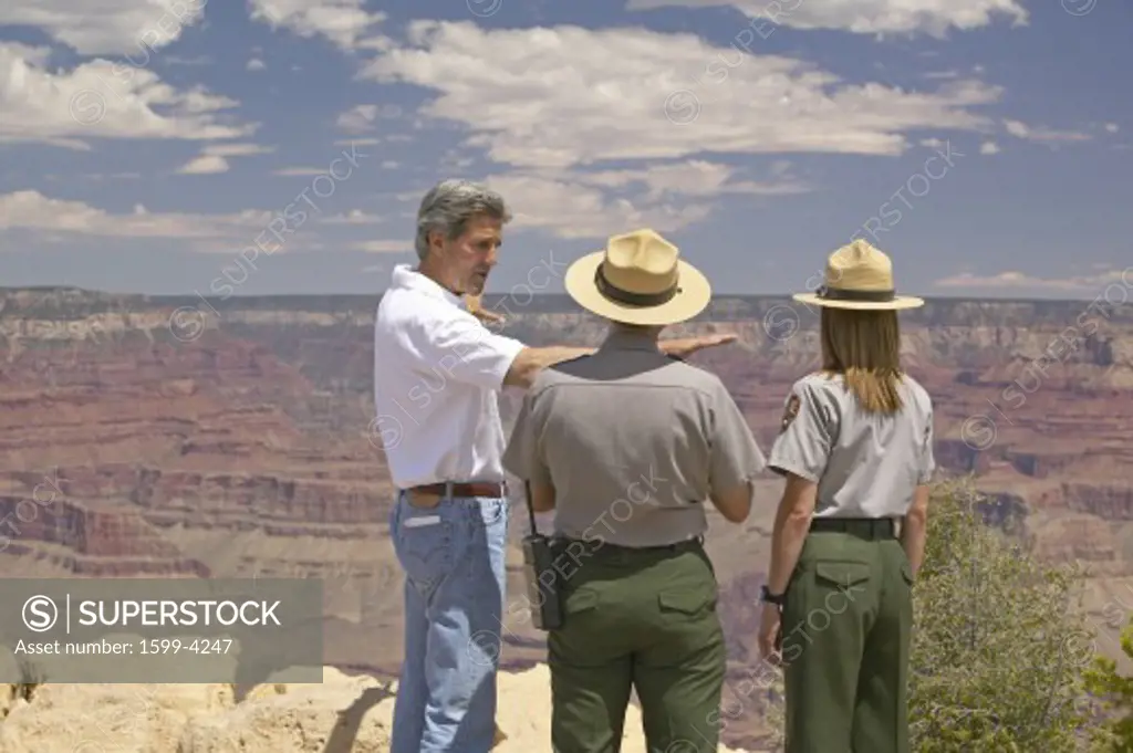 Senator John Kerry speaking with 2 rangers at rim of Bright Angel Lookout, Grand Canyon, AZ