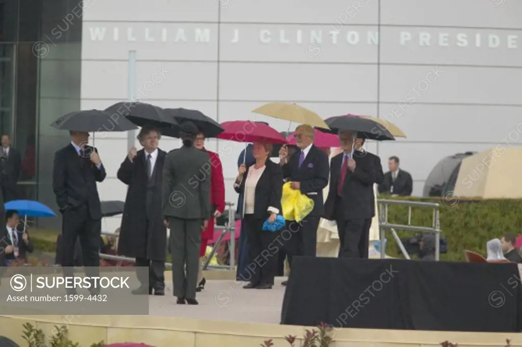 Personal guests of former U.S. President Bill Clinton along with heads of state walk on stage during the official opening ceremony of the Clinton Presidential Library November 18, 2004 in Little Rock, AK