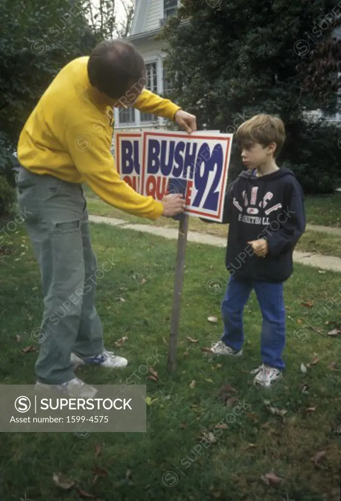Man setting up Bush/Quayle 1992 campaign sign in his yard