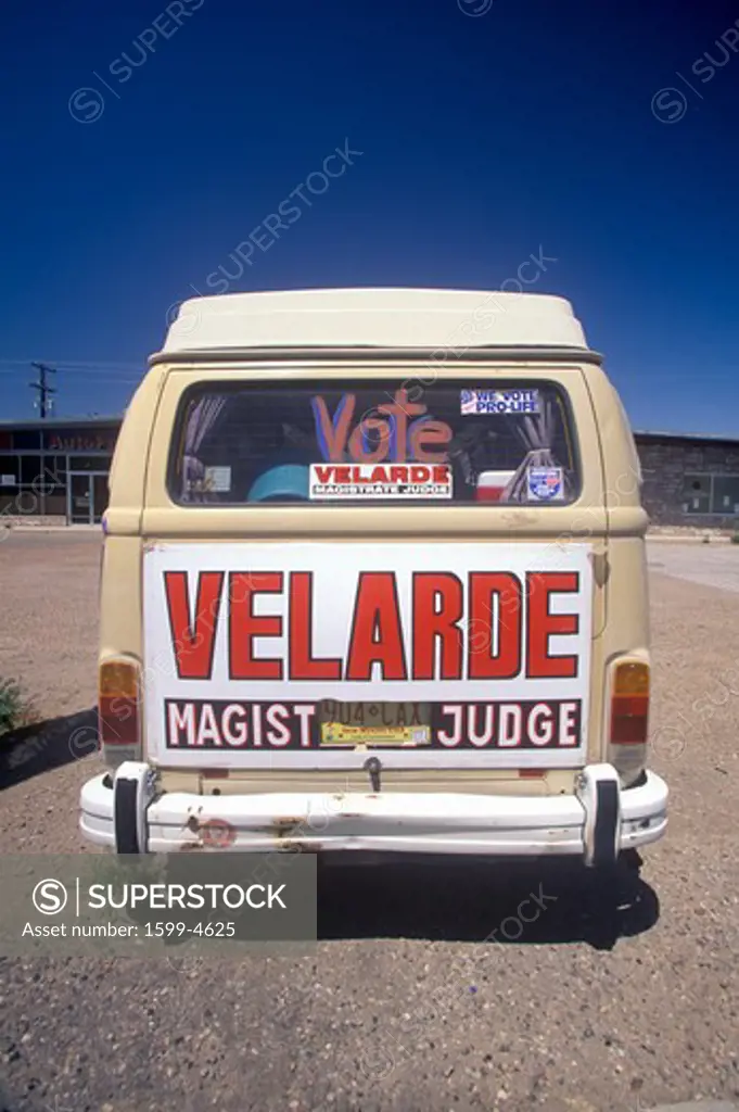 Rear view of a van with large campaign sign that reads Velarde - Magistrate Judge, NM