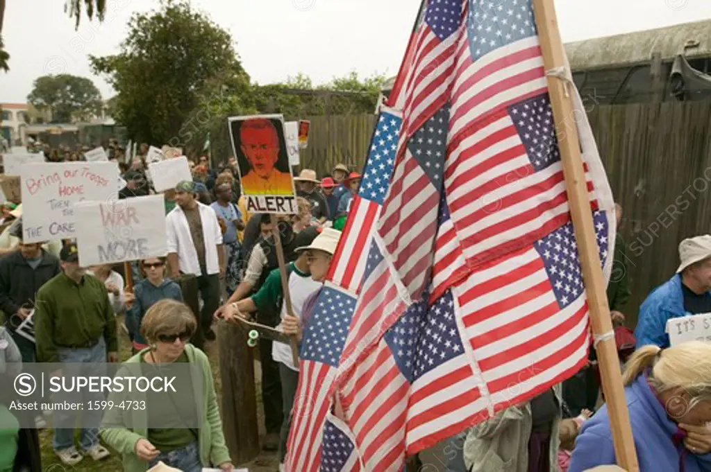 Protesters march with US Flag against President George W. Bush and the Iraq war at an anti-Iraq War protest march in Santa Barbara, California on March 17, 2007