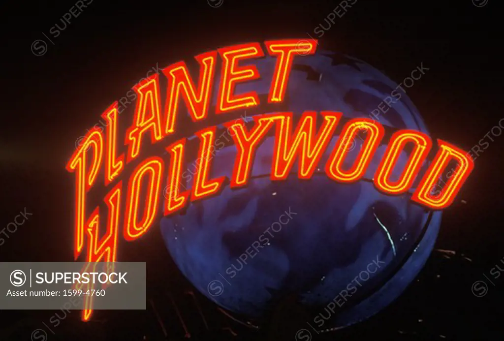 A neon sign that reads Planet Hollywood”