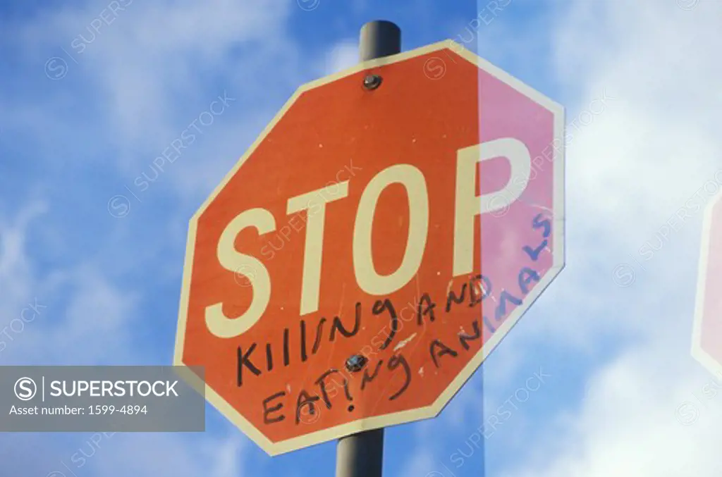 A sign that reads Stop killing and eating animals”