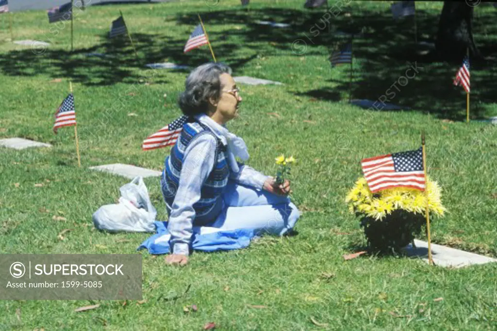 Woman Sitting in Cemetery, Memorial Day, Los Angeles, California